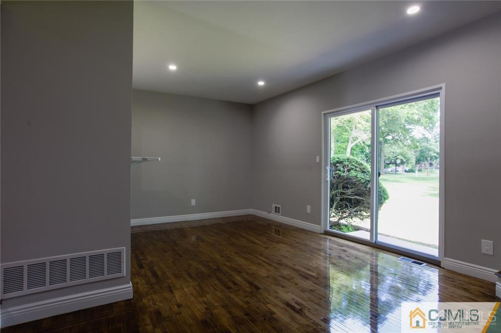 4103 Hana Road Edison, NJ 08817 - Photo 7 of 16 a view of empty room with wooden floor and fan
