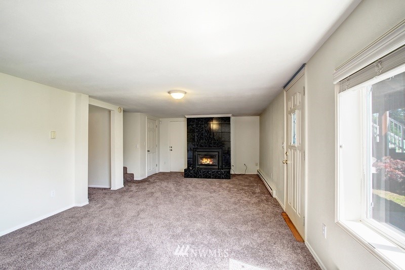 2106 Cedar Road Lake Stevens, WA 98258 - Photo 15 of 24 an empty room with a window and a fireplace