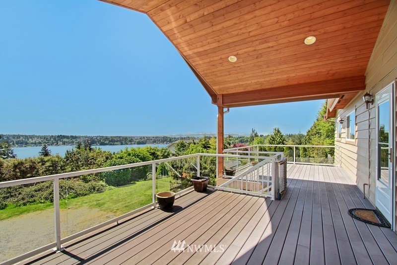 2106 Cedar Road Lake Stevens, WA 98258 - Photo 3 of 24 a view of a balcony with chairs and wooden floor