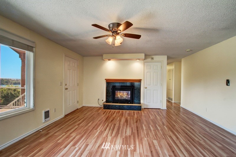 2106 Cedar Road Lake Stevens, WA 98258 - Photo 6 of 24 a view of an empty room with window and wooden floor