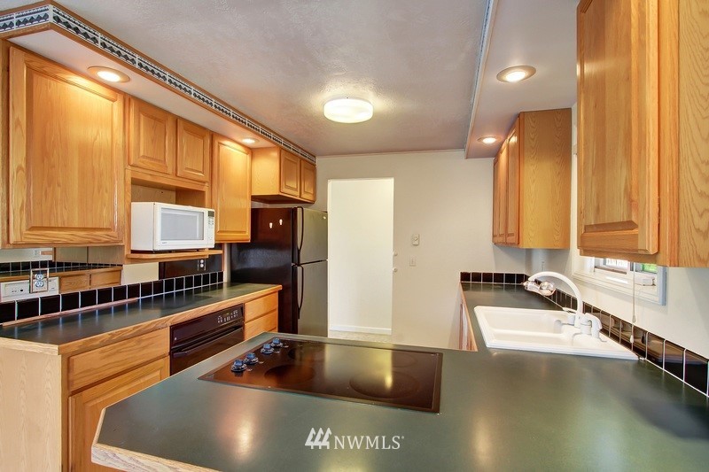 2106 Cedar Road Lake Stevens, WA 98258 - Photo 8 of 24 a kitchen with stainless steel appliances a sink a counter space and a window