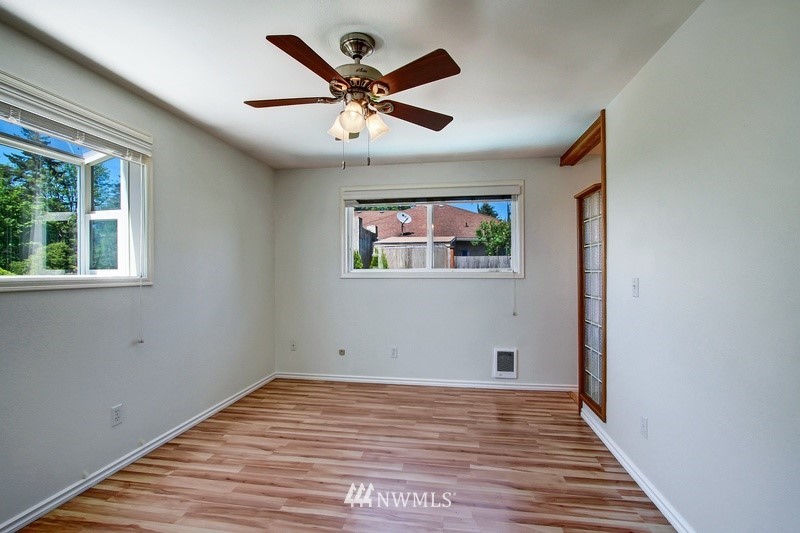 2106 Cedar Road Lake Stevens, WA 98258 - Photo 10 of 24 a view of a big room with wooden floor and windows