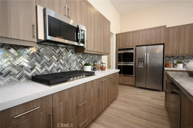 a kitchen with stainless steel appliances wooden cabinets and stove