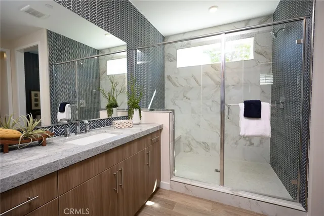 a bathroom with a double vanity sink and shower