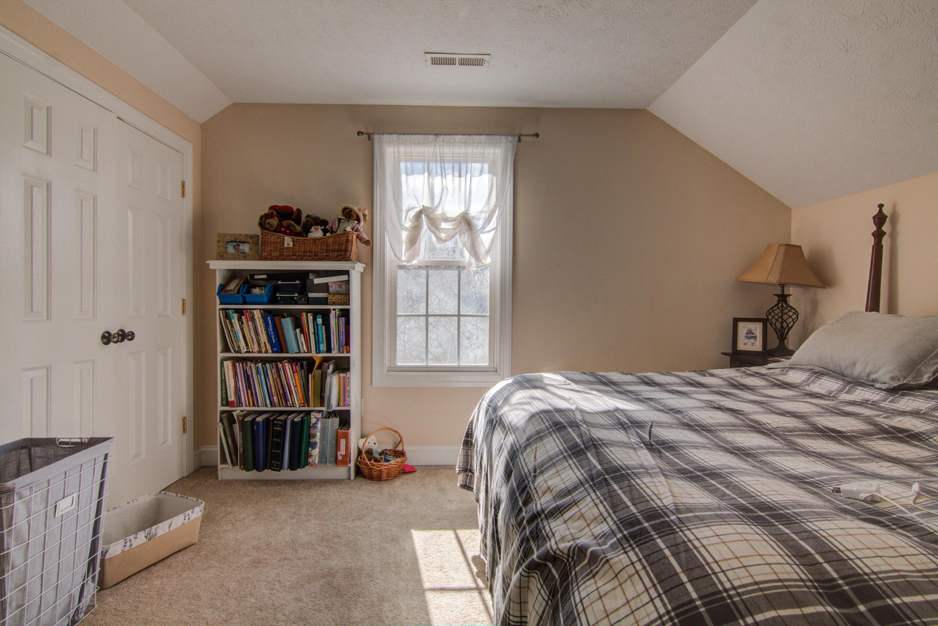 1129 Mountain View Road Vinton, VA 24179 - Photo 21 of 24 a bedroom with a bed and a book shelf