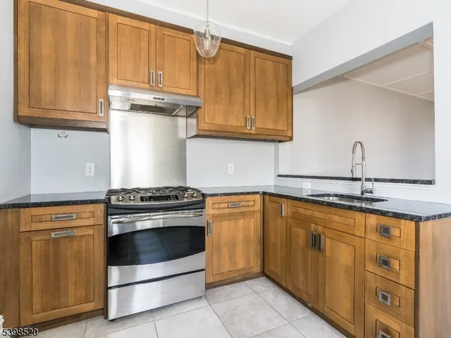 a kitchen with stainless steel appliances granite countertop a stove and a sink