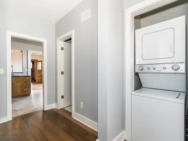 a view of washer and dryer with wooden floor