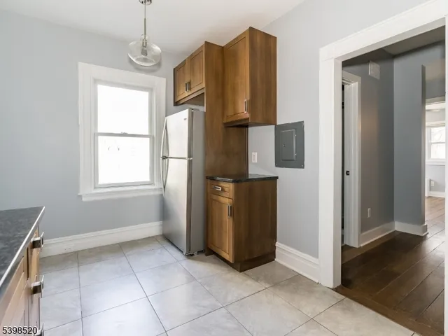 a view of kitchen with windows and refrigerator