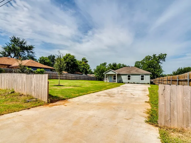 a view of house with yard and entertaining space