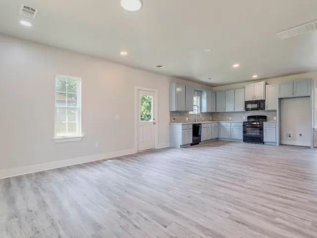 a view of a kitchen with a sink and a window