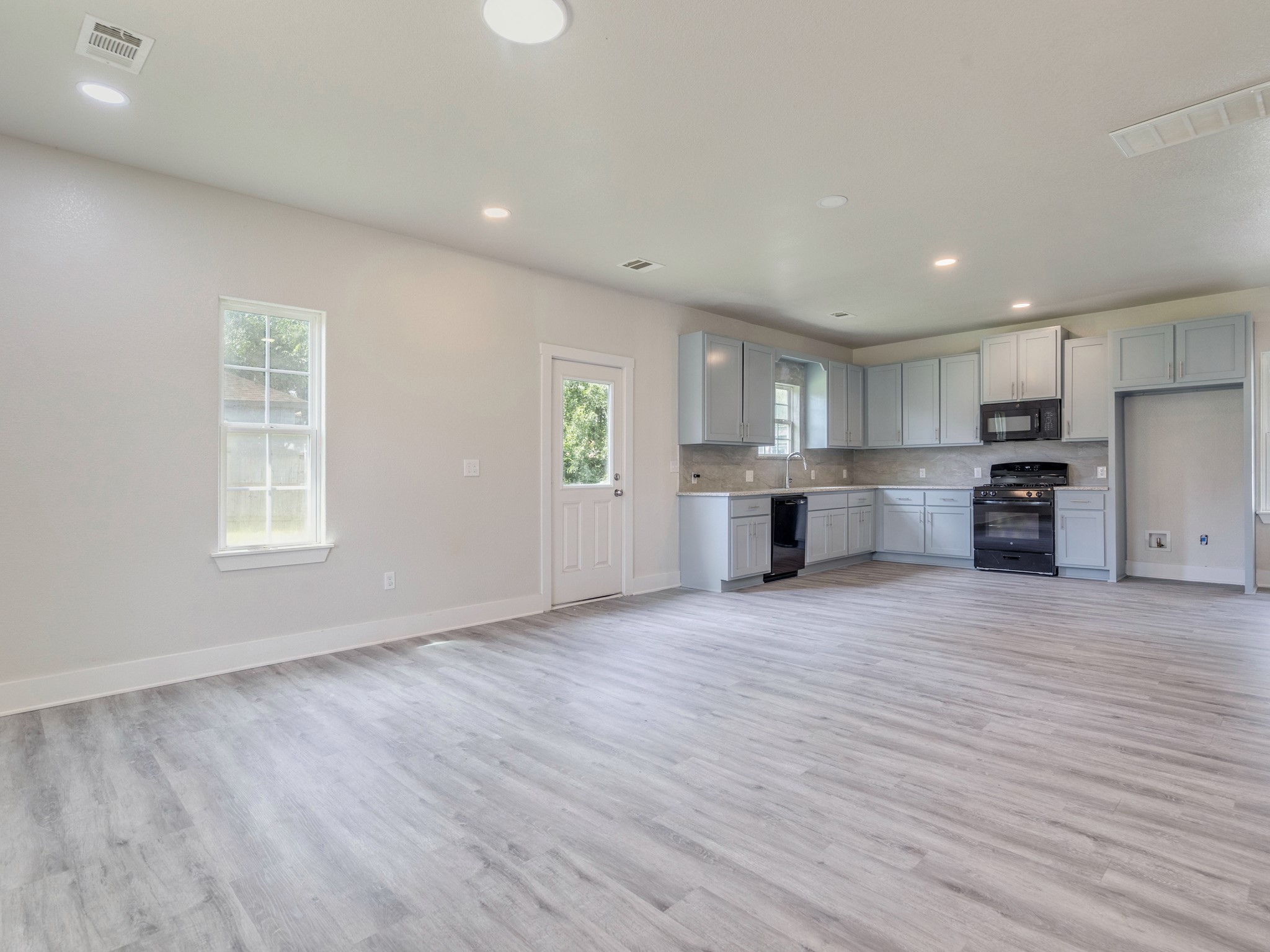411 South Ave B Elgin, TX 78621 - Photo 5 of 23 a view of a kitchen with a sink and a window