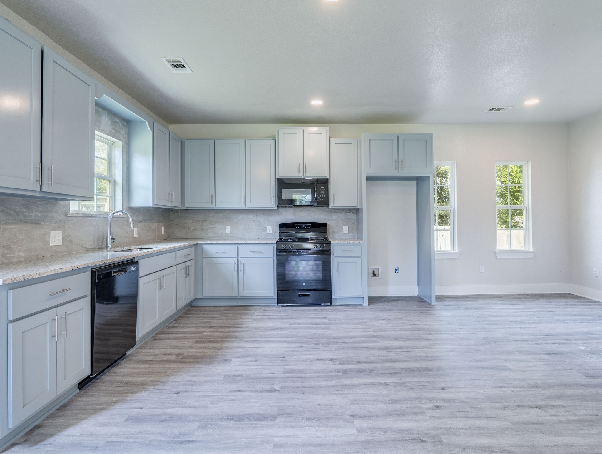 411 South Ave B Elgin, TX 78621 - Photo 9 of 23 a kitchen with a refrigerator and a stove top oven