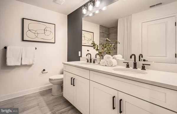 a bathroom with a toilet a sink and mirror