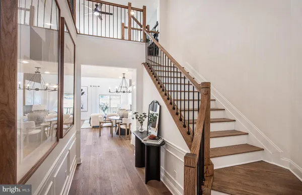 a view of entryway and hall with wooden floor