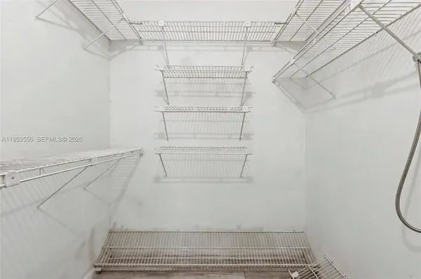 a view of walk in closet with empty racks