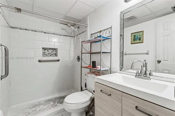 a bathroom with a sink toilet and shower