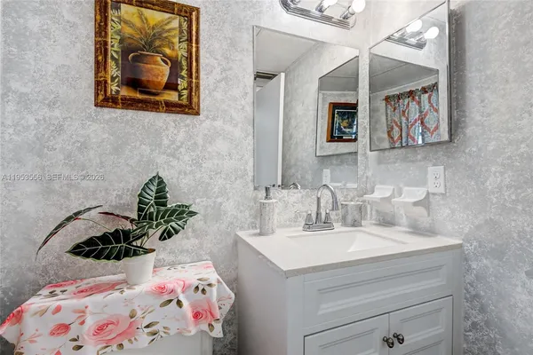 a bathroom with a sink and a mirror