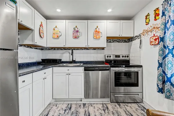 a kitchen with stainless steel appliances and cabinets