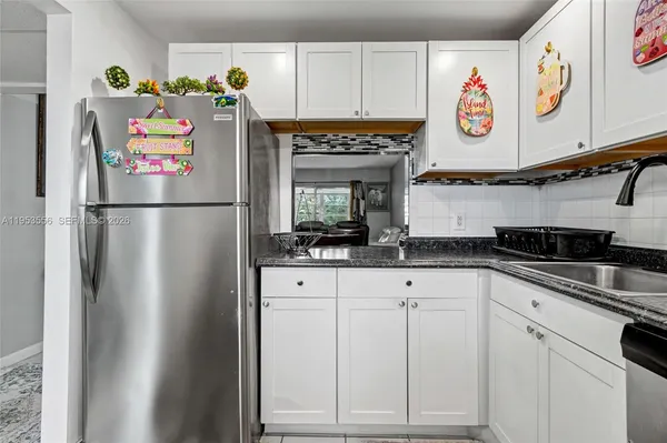 a kitchen with refrigerator and cabinets