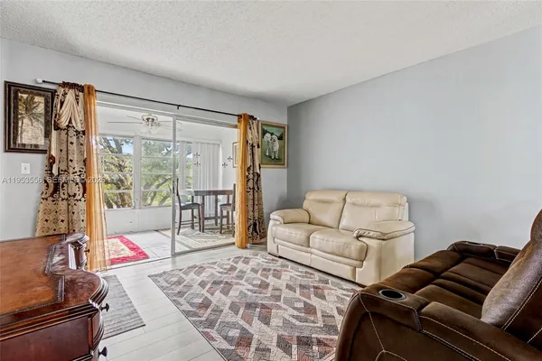 a living room with furniture and a floor to ceiling window