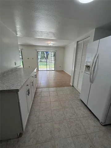 a kitchen with a stove sink and cabinets