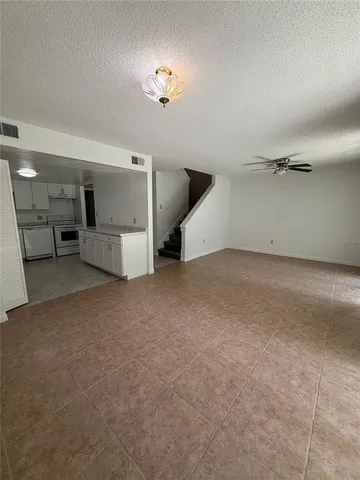 an empty room with a kitchen