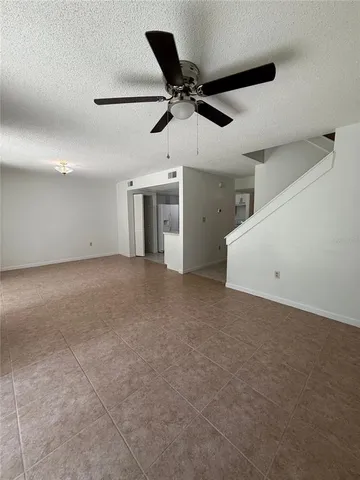 a view of a kitchen with white cabinets and wooden floor
