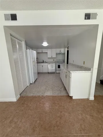 a kitchen with refrigerator and window
