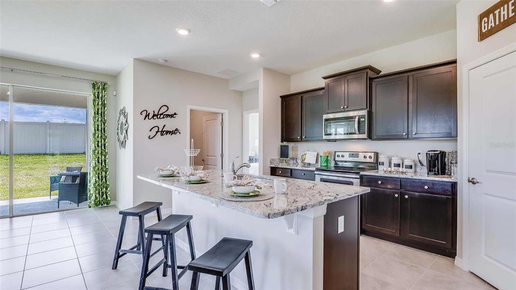 4319 Fence Row Court Lakewood Ranch, FL 34211 - Photo 3 of 39 a kitchen with a sink stove and refrigerator