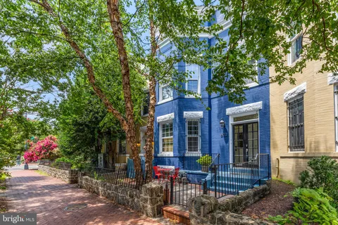 a view of a house with sitting area and garden