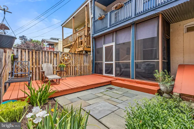 a backyard of a house with a garden and outdoor seating