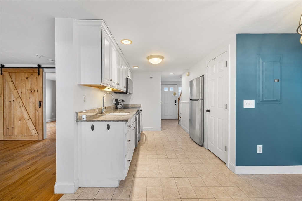 544 Shore Road, Unit 3 Truro, MA 02666 - Photo 14 of 30 a kitchen with stainless steel appliances granite countertop a refrigerator and a sink