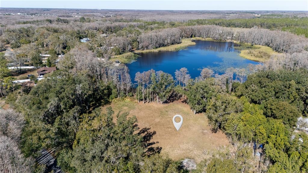 4539 Cobb Road Land O Lakes, FL 34638 - Photo 2 of 18 an aerial view of a house with a yard and lake view
