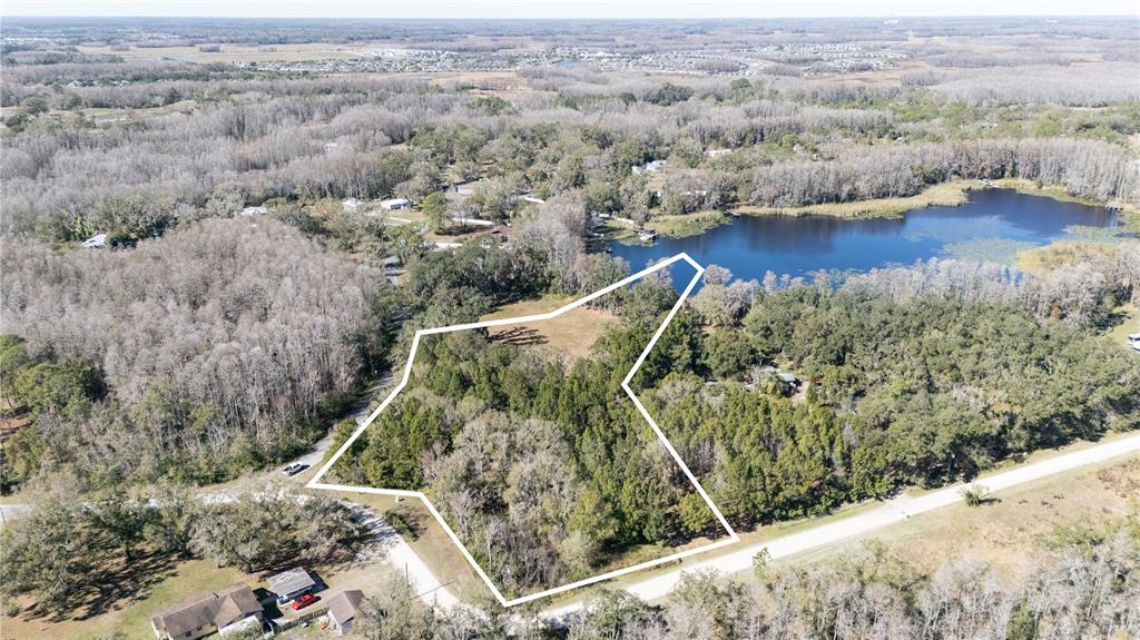 4539 Cobb Road Land O Lakes, FL 34638 - Photo 9 of 18 an aerial view of a house with a yard and lake view