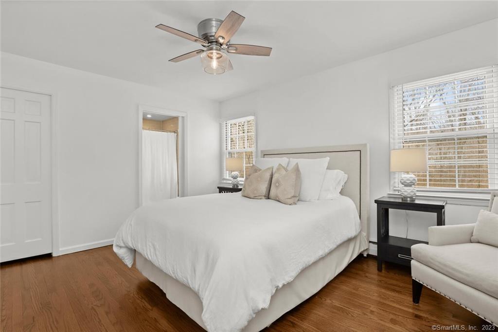 183 Frogtown Road New Canaan, CT 06840 - Photo 16 of 37 a bedroom with a large bed chandelier and a window