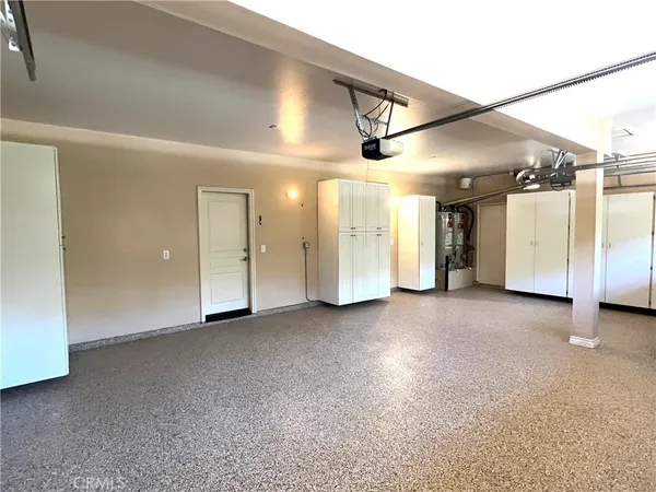 a large kitchen with stainless steel appliances granite countertop a stove a sink and a refrigerator