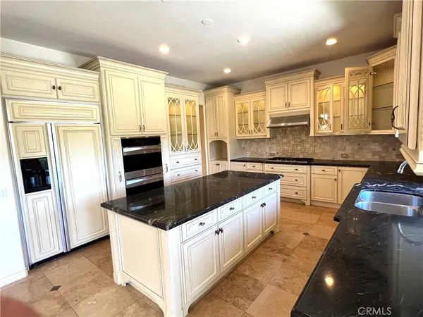 a kitchen with granite countertop a stove and a large window