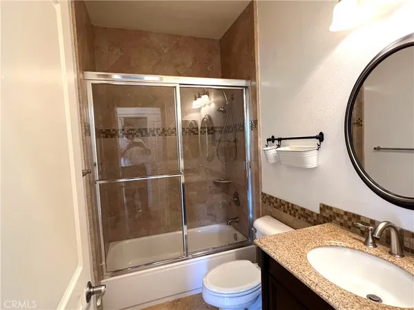 a view of a hallway with wooden floor and closet