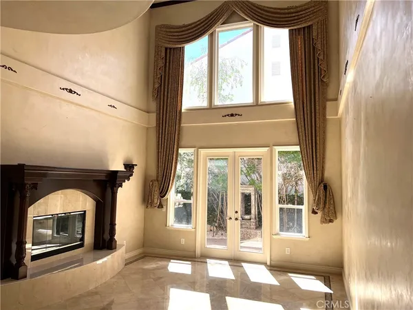 a living room with a fireplace and a window