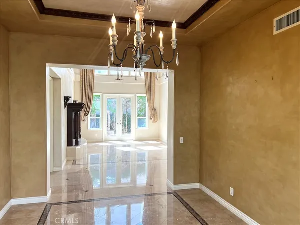 a front view of a house with a door and tree