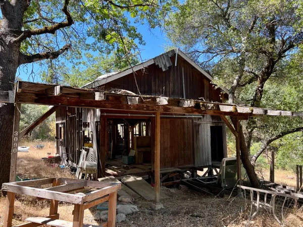 a view of a backyard of a house with a yard and mountain view