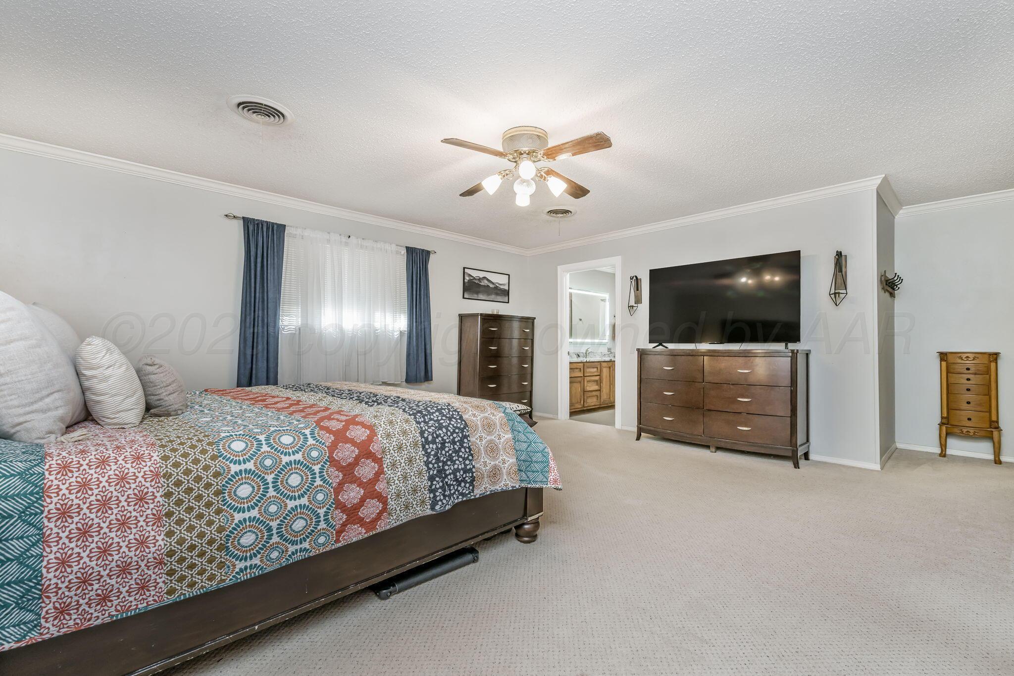 801 Arrah Friona, TX 79035 - Photo 11 of 37 a spacious bedroom with a bed and a flat screen tv