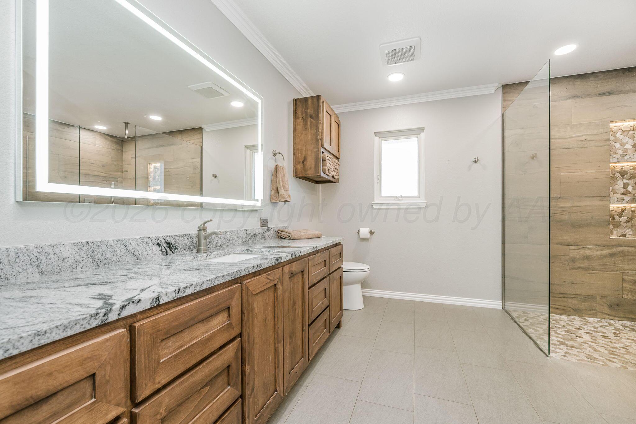 801 Arrah Friona, TX 79035 - Photo 14 of 37 a bathroom with a granite countertop sink mirror and a