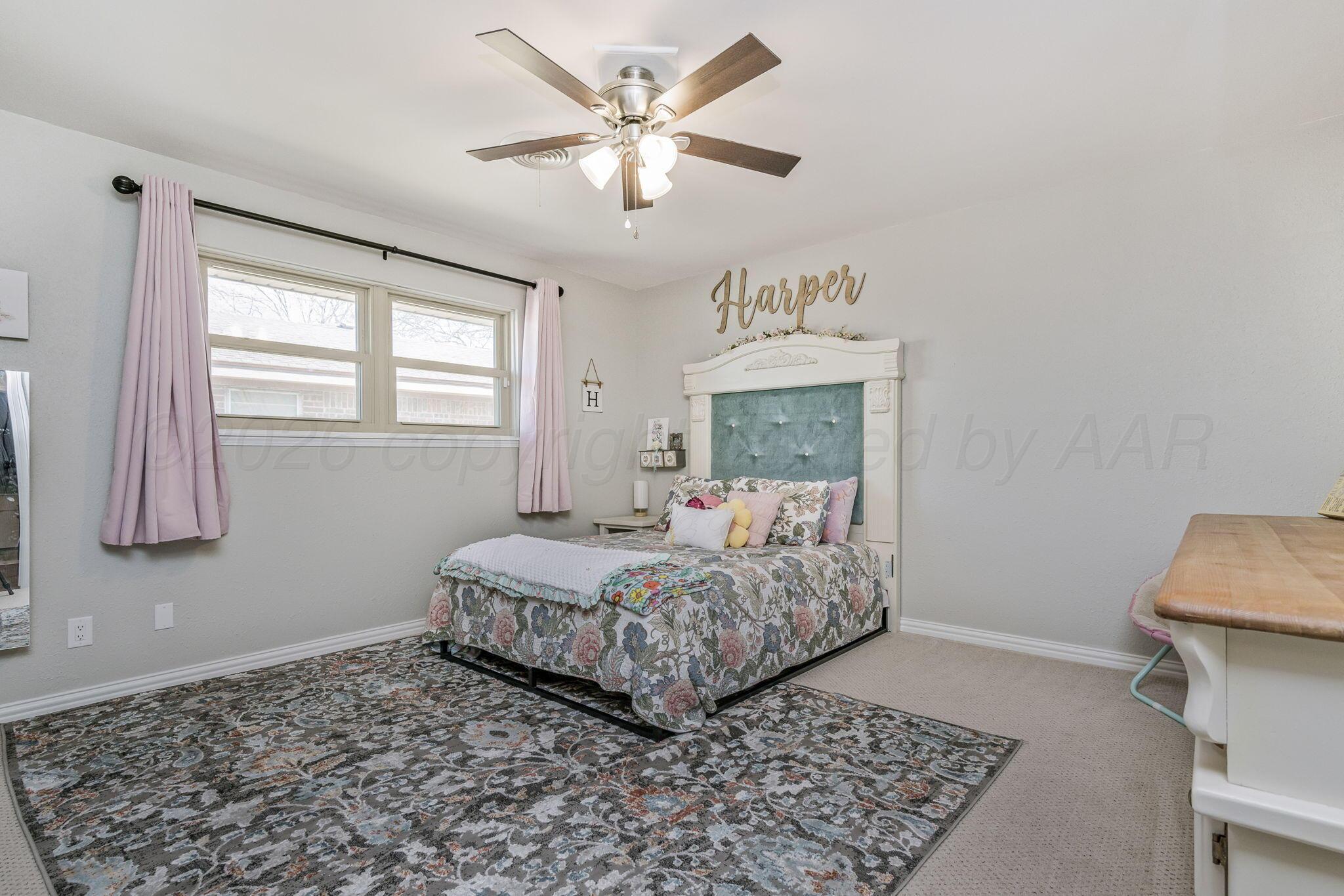 801 Arrah Friona, TX 79035 - Photo 20 of 37 a bedroom with a bed and a table in it with window