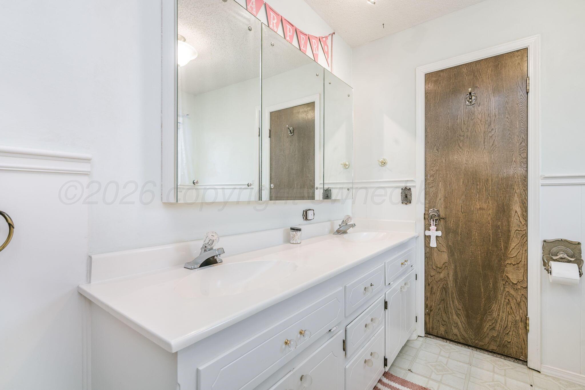 801 Arrah Friona, TX 79035 - Photo 22 of 37 a bathroom with a sink and a mirror