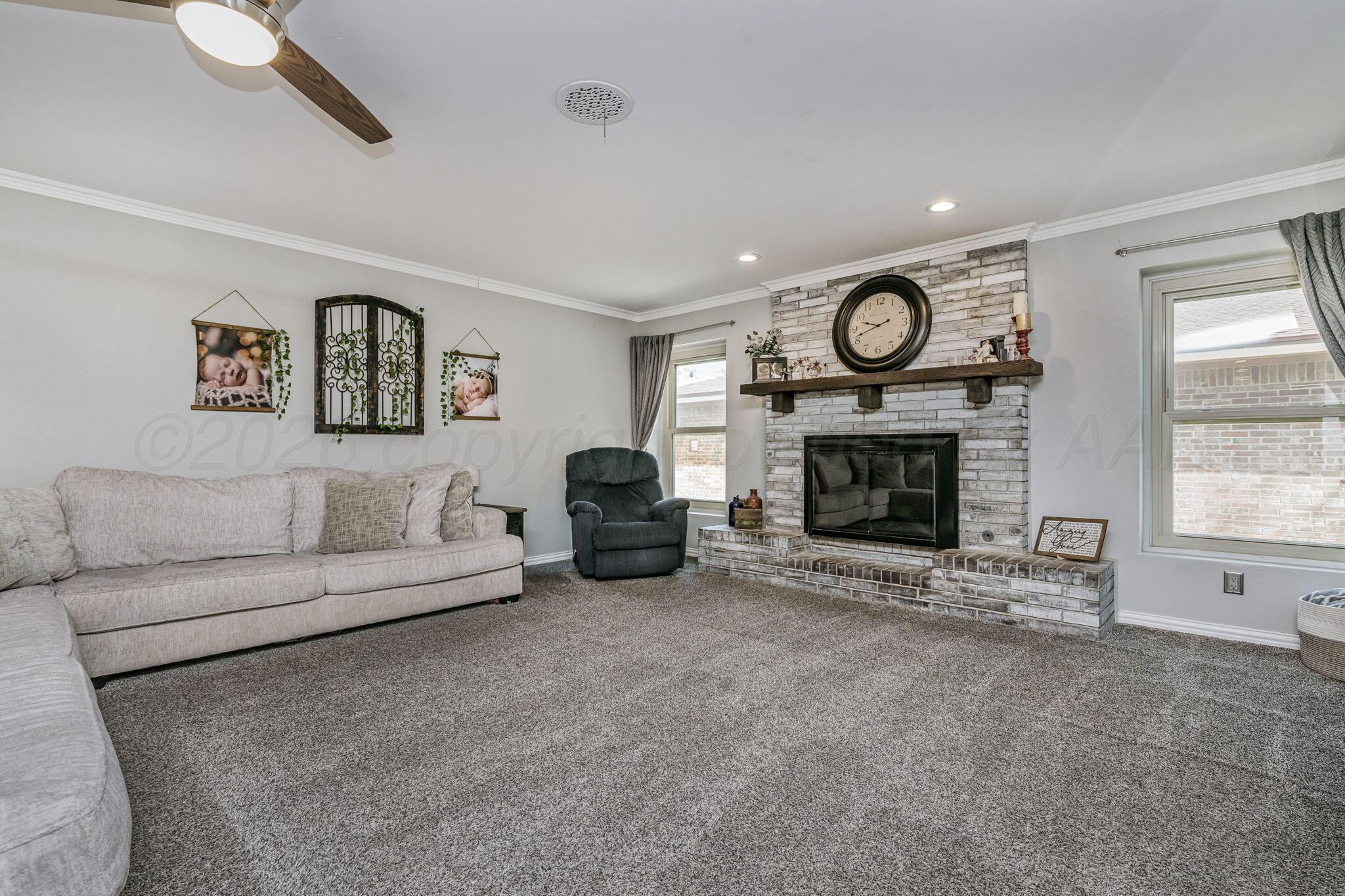801 Arrah Friona, TX 79035 - Photo 3 of 37 a living room with furniture a fireplace and a large window