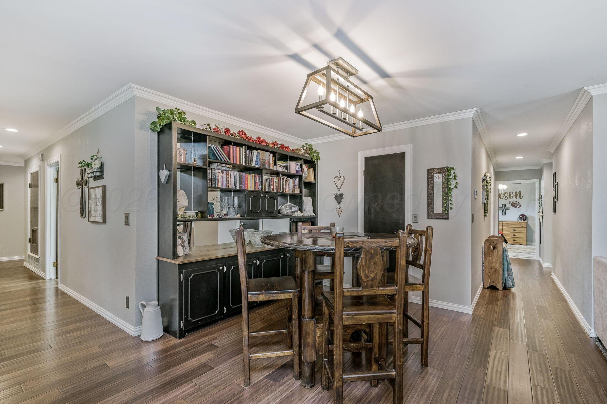 801 Arrah Friona, TX 79035 - Photo 5 of 37 a view of a dining room with furniture and wooden floor