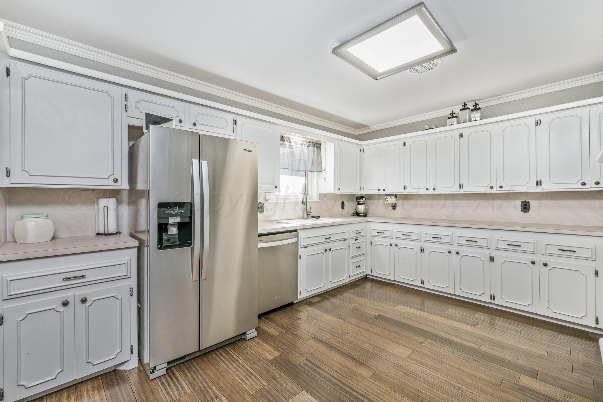 801 Arrah Friona, TX 79035 - Photo 6 of 37 a kitchen with white cabinets and white appliances