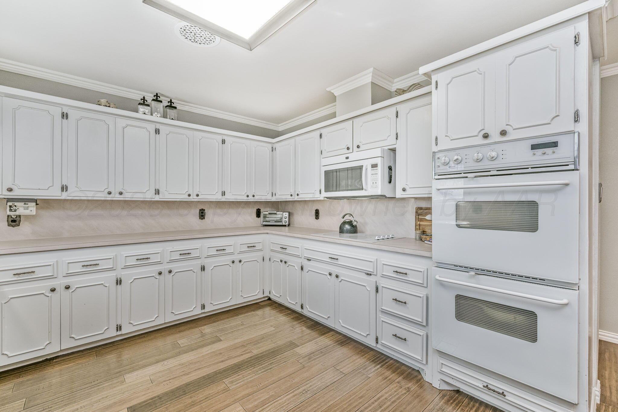 801 Arrah Friona, TX 79035 - Photo 7 of 37 a kitchen with white cabinets white stainless steel appliances and sink