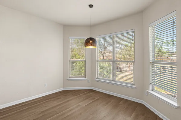 a kitchen with stainless steel appliances granite countertop a sink a stove and a wooden floors